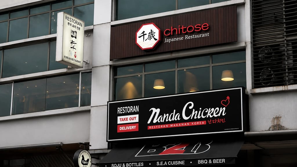Chitose Japanese Restaurant brand identity signage featuring Japanese calligraphy logo, octagonal crest frame, and golden wave motif — Japanese restaurant branding and creative direction by Serah Siew