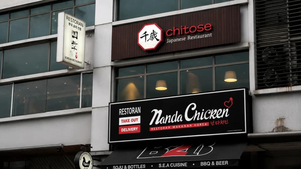 Chitose Japanese Restaurant brand identity signage featuring Japanese calligraphy logo, octagonal crest frame, and golden wave motif — Japanese restaurant branding and creative direction by Serah Siew